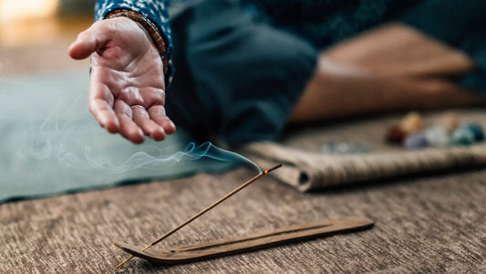 A man meditating with incense stick