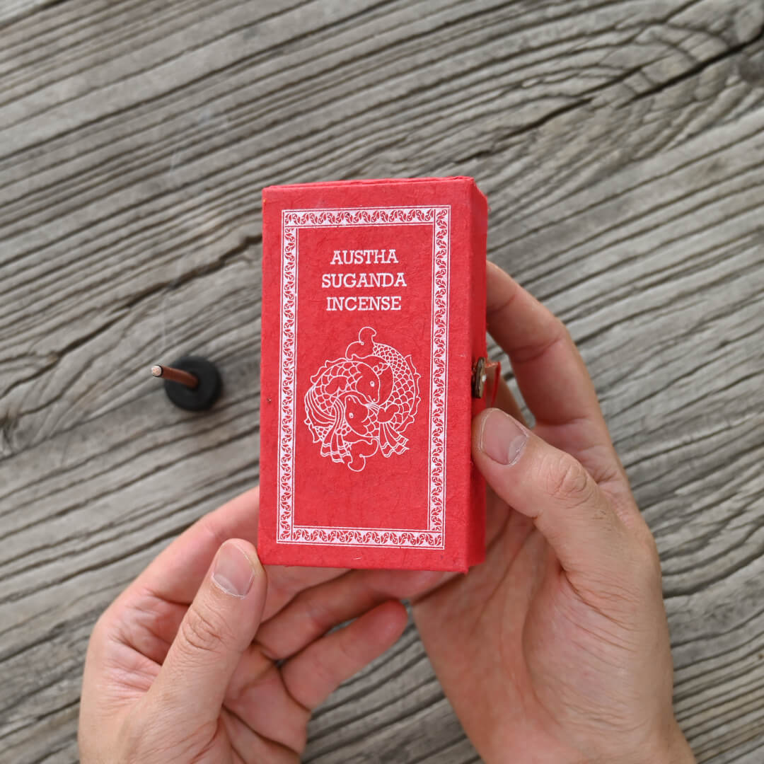 hands holding Austha Suganda Incense Box from Nepal