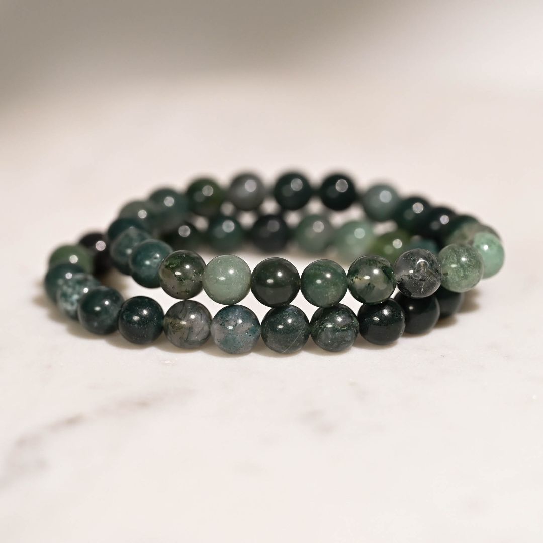 Moss Agate Bracelets on table