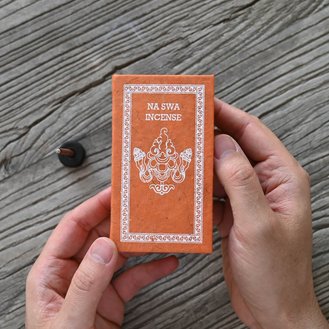 Hands holding Na Swa Incense Stick Box