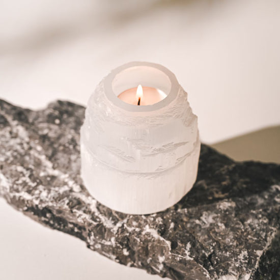 a lit candle inside selenite crystal candle holder 