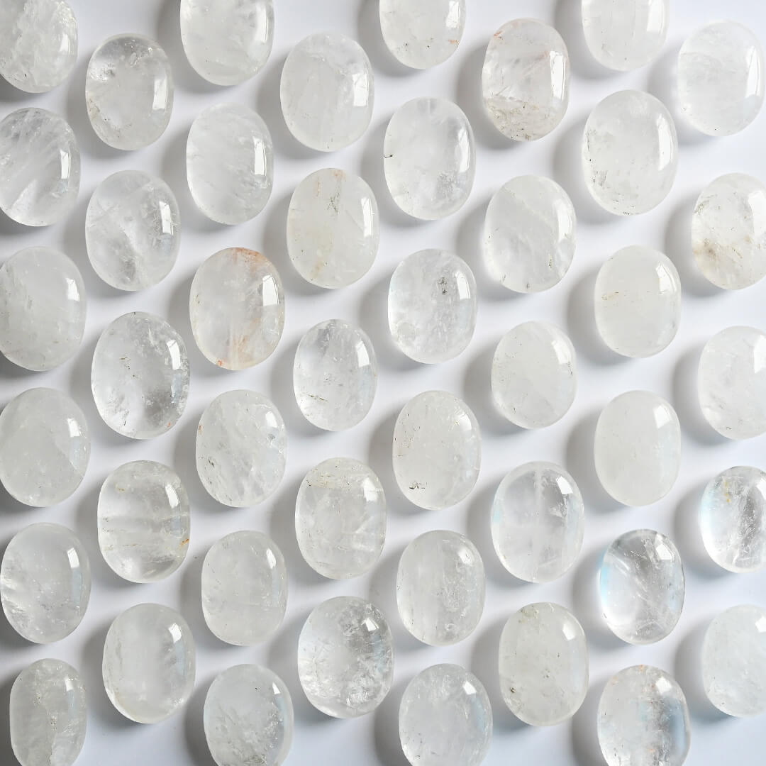 Clear Quartz Palm Stone placed on table