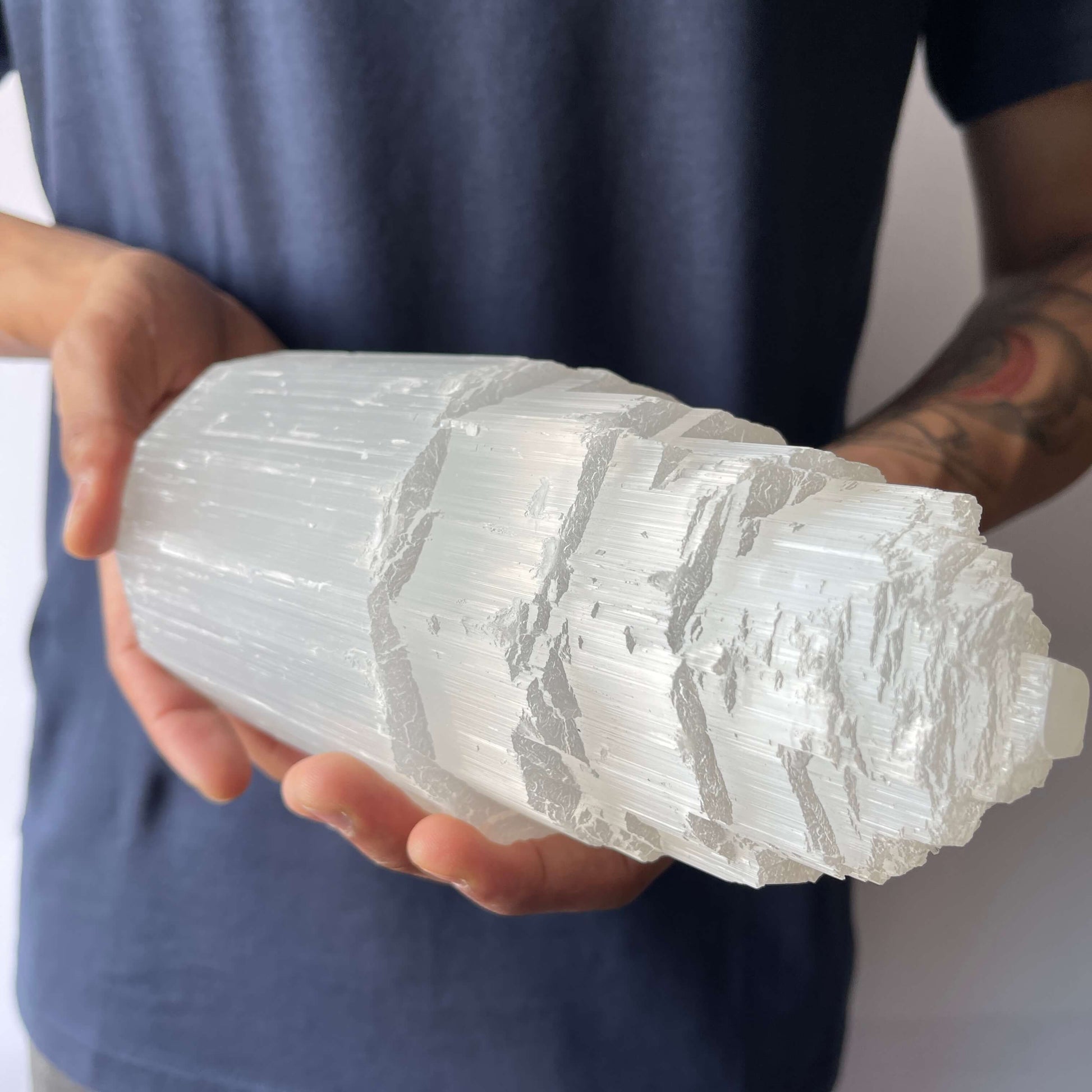 A man showing A Selenite Crystal Tower - 20cm 